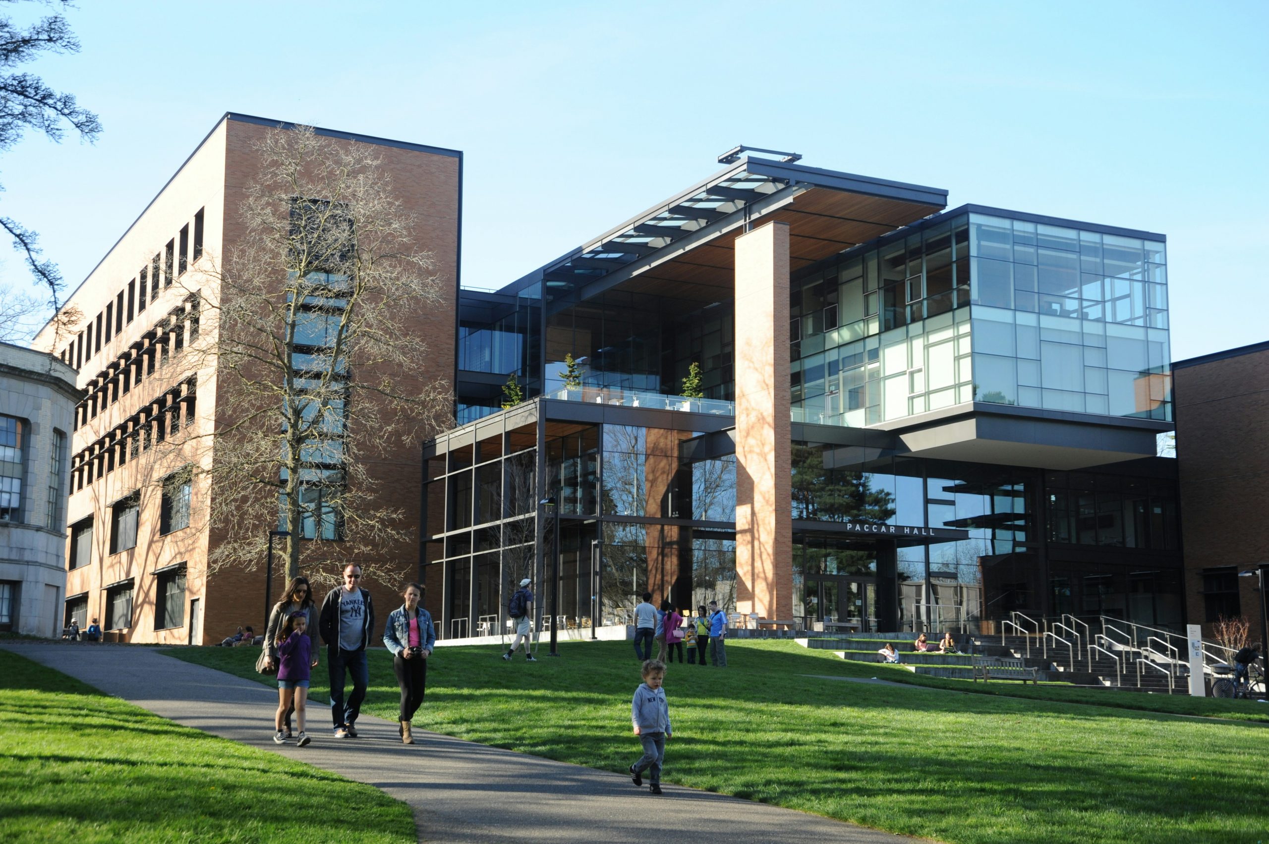 A photo of an outdoor path across campus at the University of Washington, where students and faculty are walking.