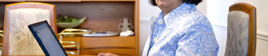 Donna Jodhan writing at a laptop.