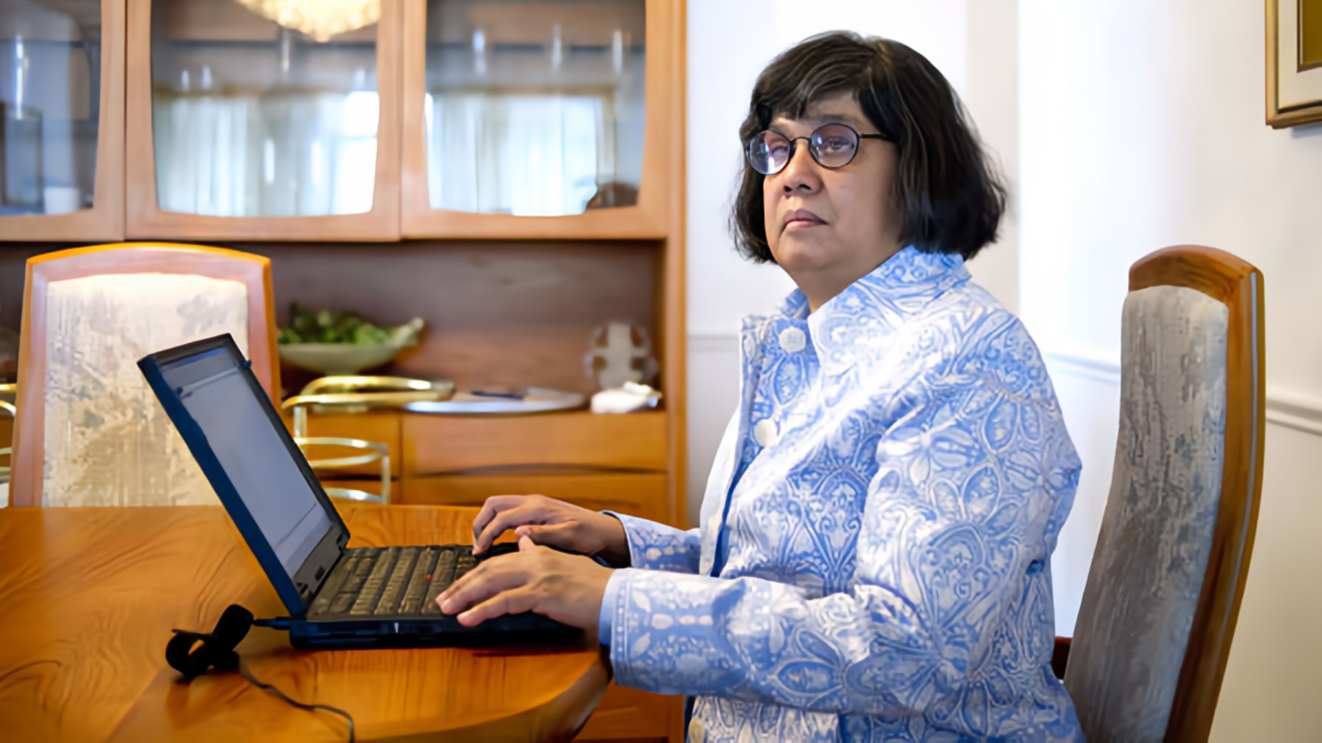 Donna Jodhan writing at a laptop.